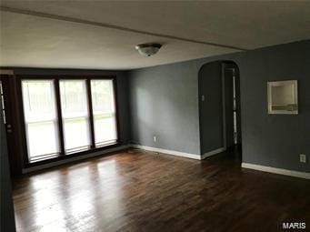 unfurnished room featuring dark hardwood / wood-style flooring