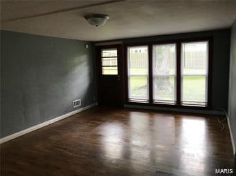 unfurnished room with dark hardwood / wood-style floors