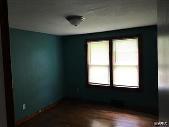 empty room featuring wood-type flooring