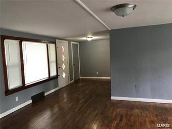 spare room featuring dark hardwood / wood-style floors