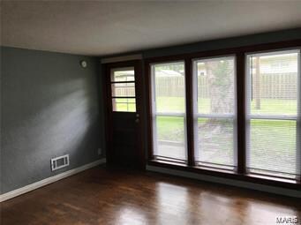 unfurnished room featuring dark hardwood / wood-style flooring