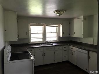 kitchen featuring white cabinetry and white electric range