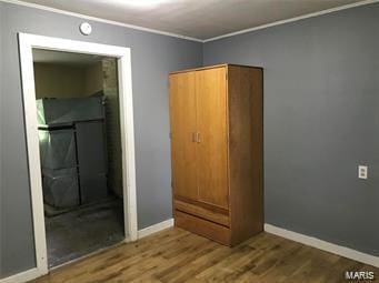 interior space featuring wood-type flooring and ornamental molding