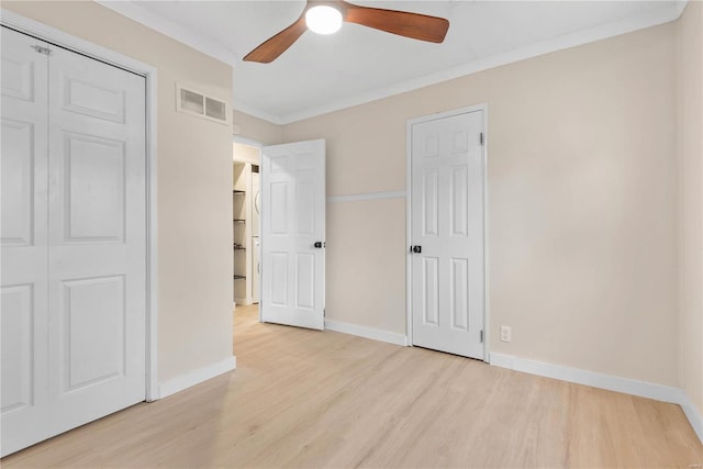 unfurnished bedroom with ceiling fan, crown molding, and light hardwood / wood-style flooring