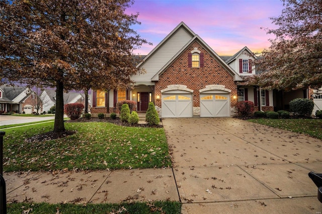 view of front of house with a yard and a garage