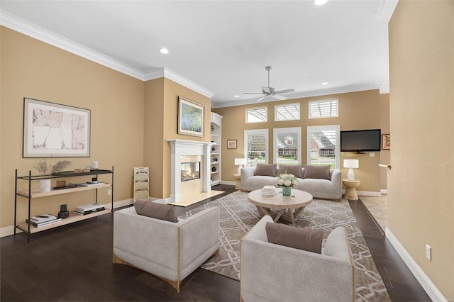 living room with dark hardwood / wood-style flooring, a high end fireplace, and ornamental molding