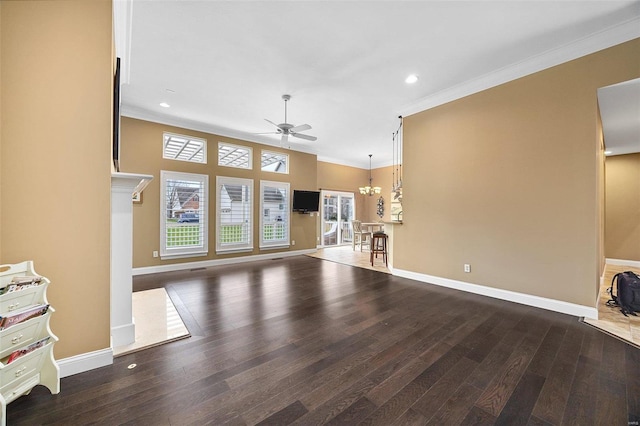 unfurnished living room with ceiling fan with notable chandelier, dark hardwood / wood-style floors, and ornamental molding