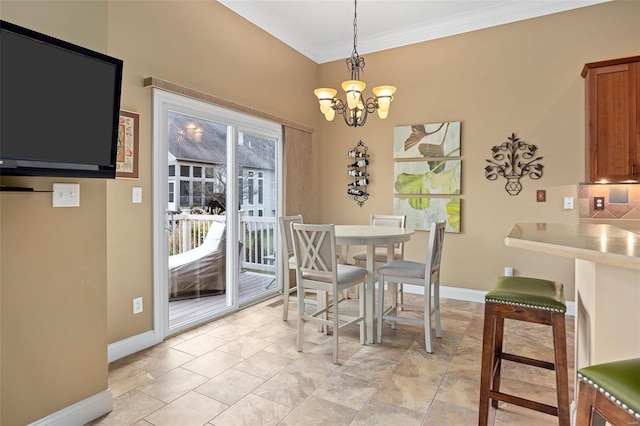 dining space featuring ornamental molding and a notable chandelier