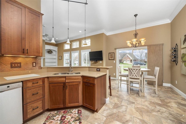 kitchen featuring sink, hanging light fixtures, an inviting chandelier, tasteful backsplash, and white dishwasher