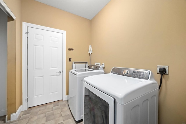 clothes washing area featuring independent washer and dryer