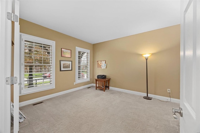 spare room with light colored carpet