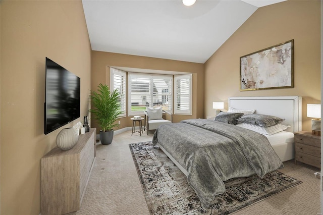 carpeted bedroom featuring lofted ceiling