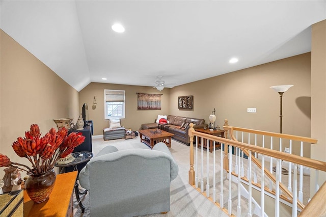 carpeted living room with ceiling fan and lofted ceiling