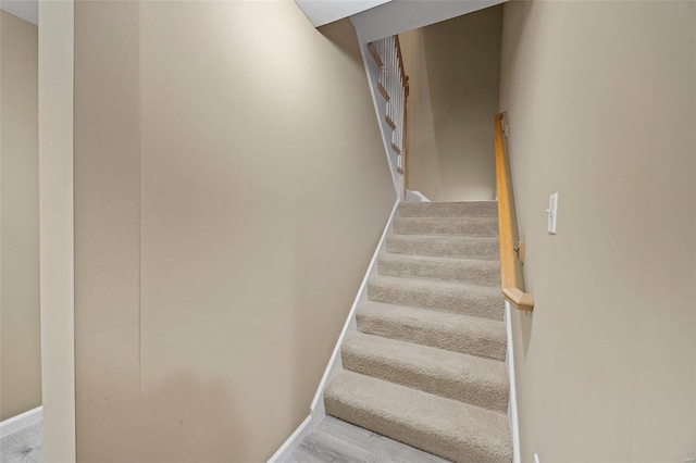 stairs featuring hardwood / wood-style flooring