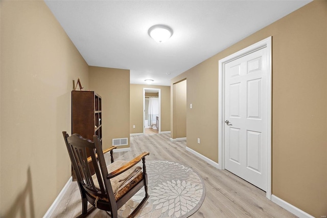 sitting room featuring light hardwood / wood-style flooring