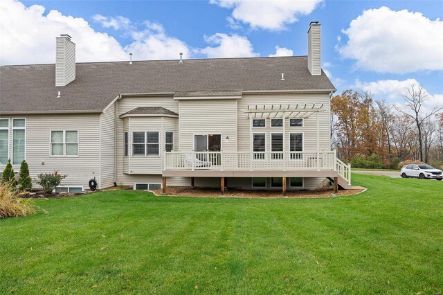 back of property featuring a pergola, a deck, and a lawn