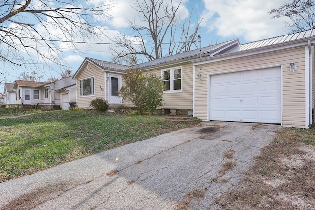 single story home featuring a front yard and a garage