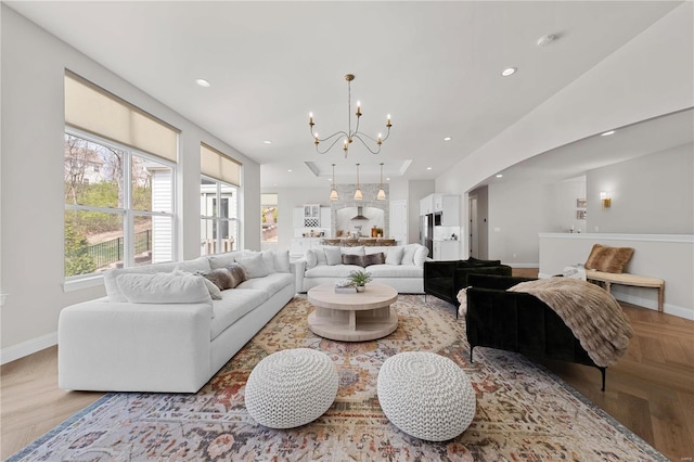 living room featuring a notable chandelier