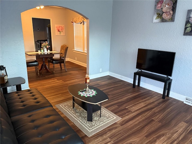 living room with dark hardwood / wood-style flooring