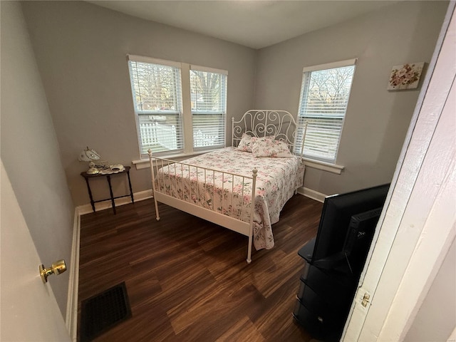 bedroom featuring dark hardwood / wood-style flooring