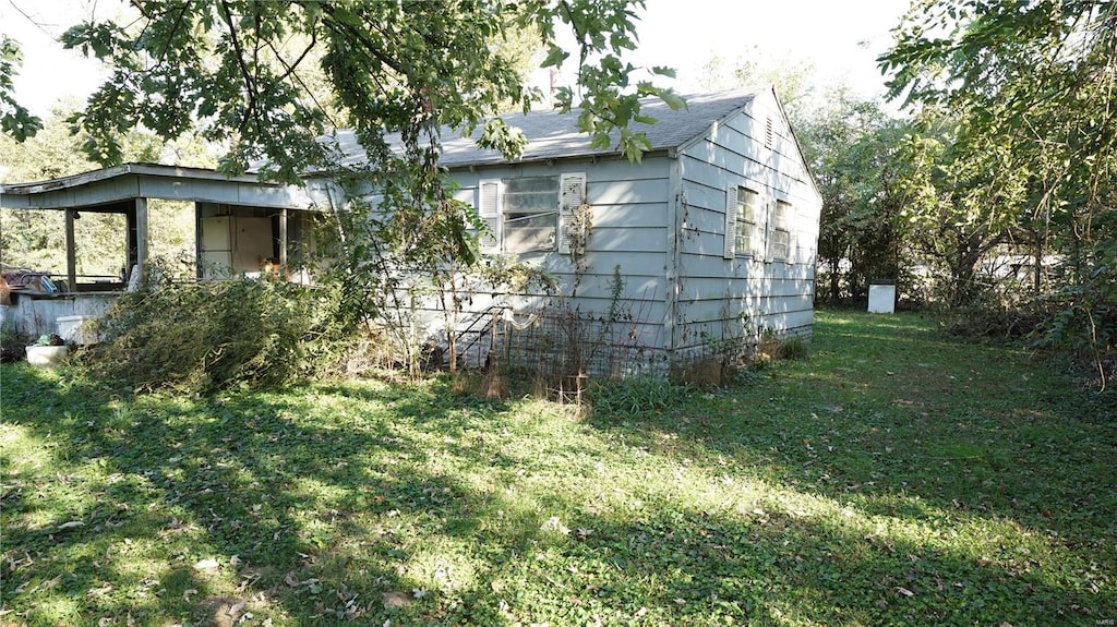 view of side of home featuring a yard