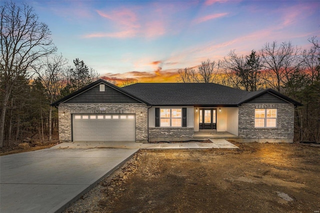 ranch-style house with driveway and an attached garage