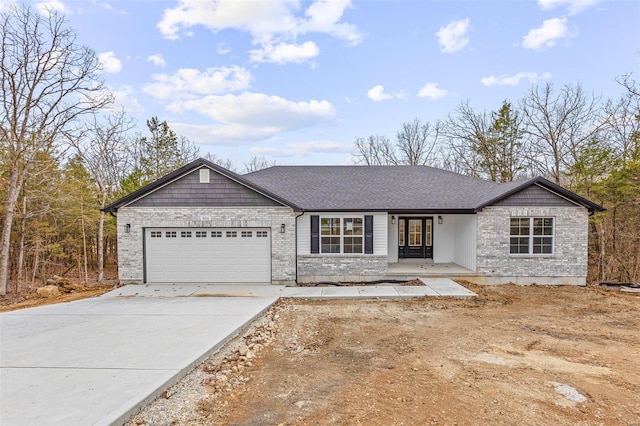 ranch-style home with an attached garage, concrete driveway, and roof with shingles