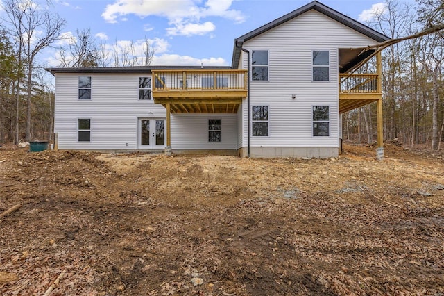 rear view of house featuring a deck and french doors