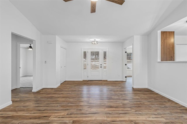 unfurnished room featuring ceiling fan, baseboards, and wood finished floors