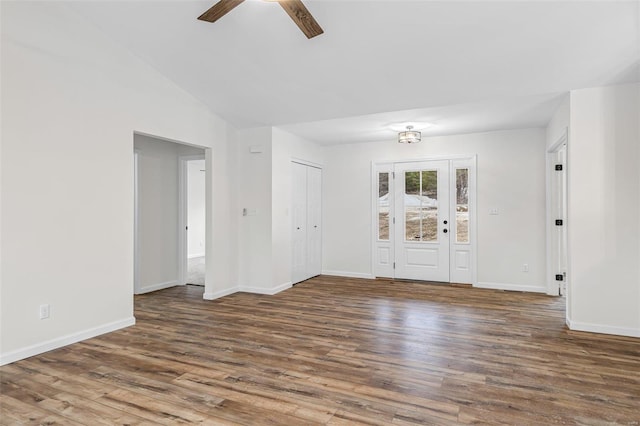 spare room with baseboards and wood finished floors