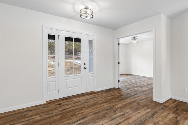 interior space with dark wood-style floors and baseboards