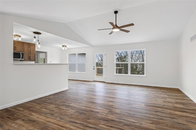 unfurnished living room with ceiling fan, dark wood-type flooring, lofted ceiling, and visible vents