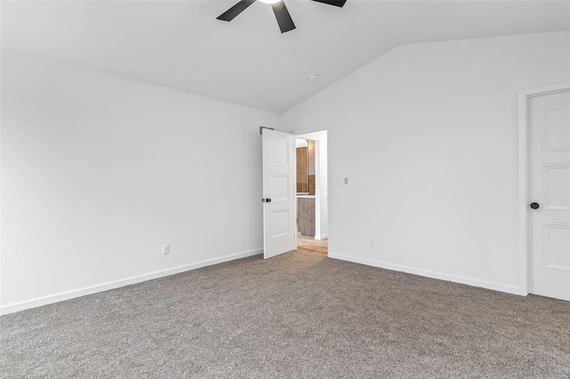 unfurnished bedroom featuring a ceiling fan, lofted ceiling, baseboards, and carpet