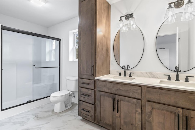 full bath with toilet, marble finish floor, a sink, and a stall shower