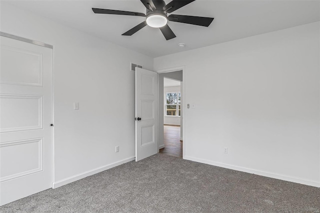 unfurnished bedroom featuring carpet, visible vents, ceiling fan, and baseboards