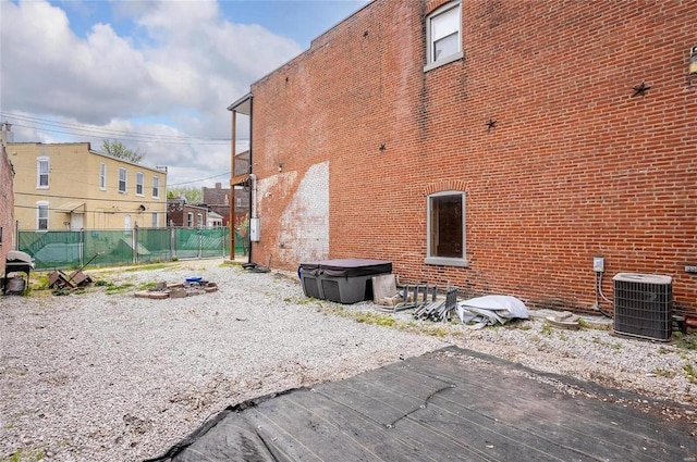 view of home's exterior with central AC and a deck