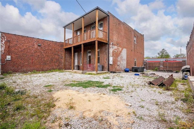 rear view of property featuring a balcony