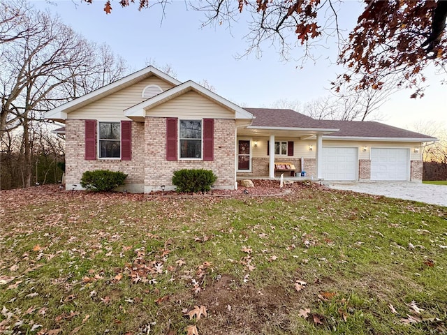 single story home with covered porch, a garage, and a front lawn