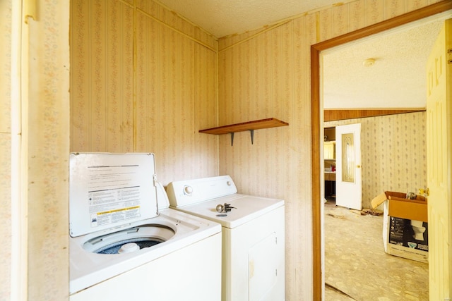 washroom featuring carpet floors, washer and dryer, and a textured ceiling