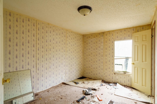 spare room with a textured ceiling