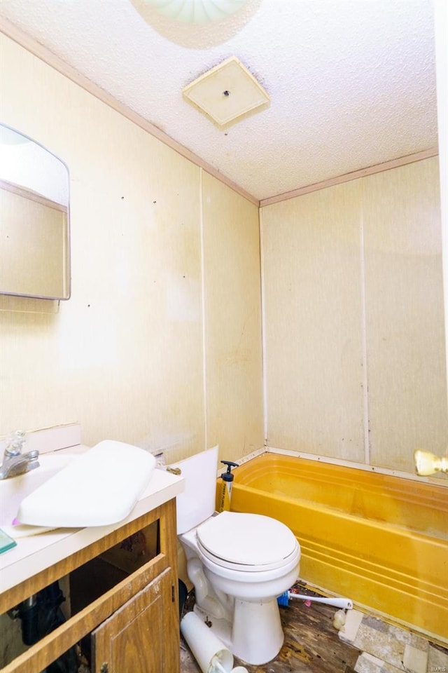 bathroom featuring a textured ceiling, vanity, and toilet