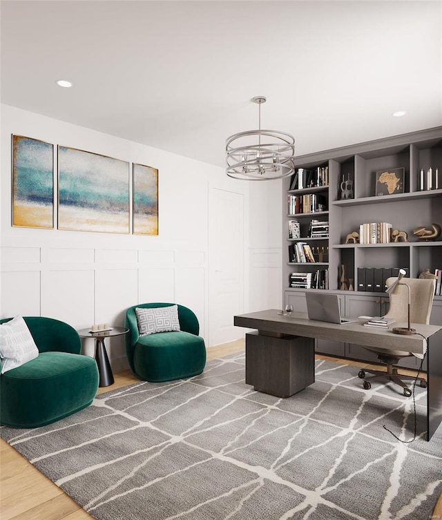 sitting room featuring hardwood / wood-style floors and a notable chandelier