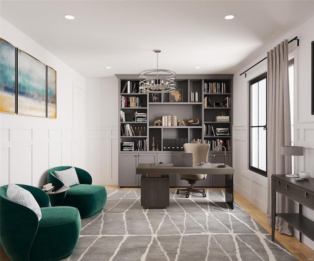 office area with hardwood / wood-style floors and a notable chandelier