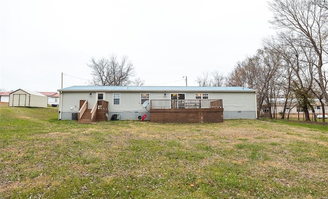 back of house with a wooden deck and a yard