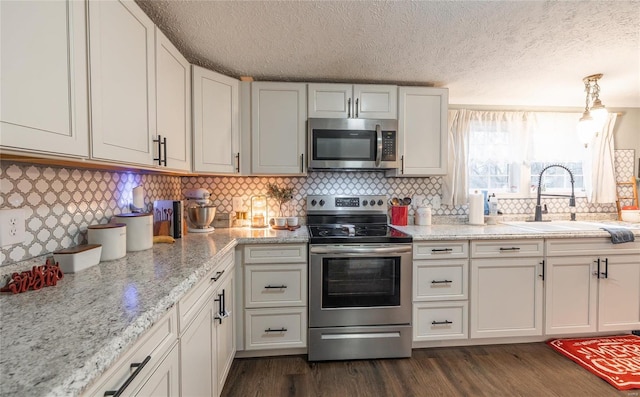 kitchen featuring sink, white cabinets, a textured ceiling, and appliances with stainless steel finishes