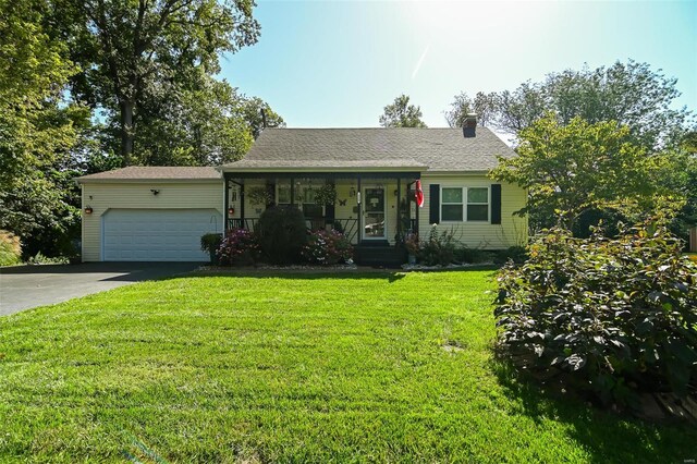 ranch-style house featuring a front lawn and a garage