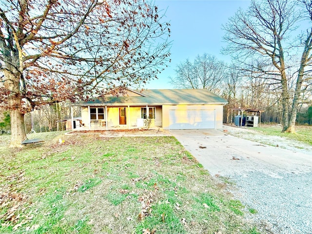 ranch-style house with a garage, covered porch, and a front lawn