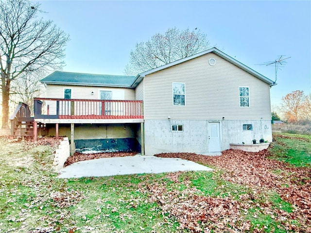 rear view of house with a deck and a patio