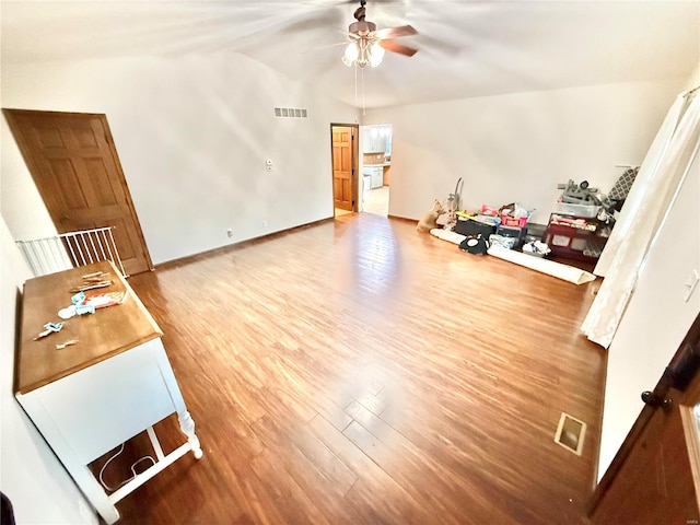 living room featuring wood-type flooring, vaulted ceiling, and ceiling fan