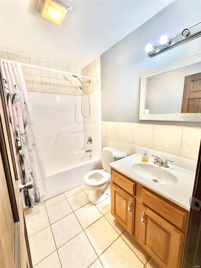 full bathroom featuring shower / bath combination with curtain, vanity, tile walls, tile patterned flooring, and toilet